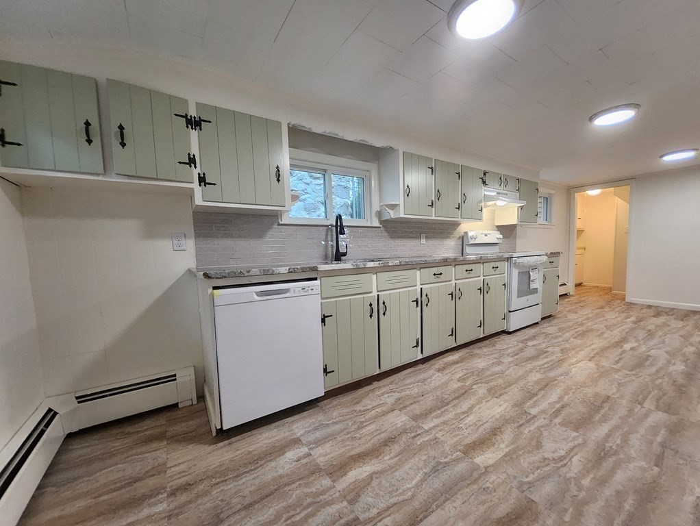 2 Grove Street Methuen, MA 01844 - Photo 12 of 15 a kitchen with a sink cabinets and wooden floor