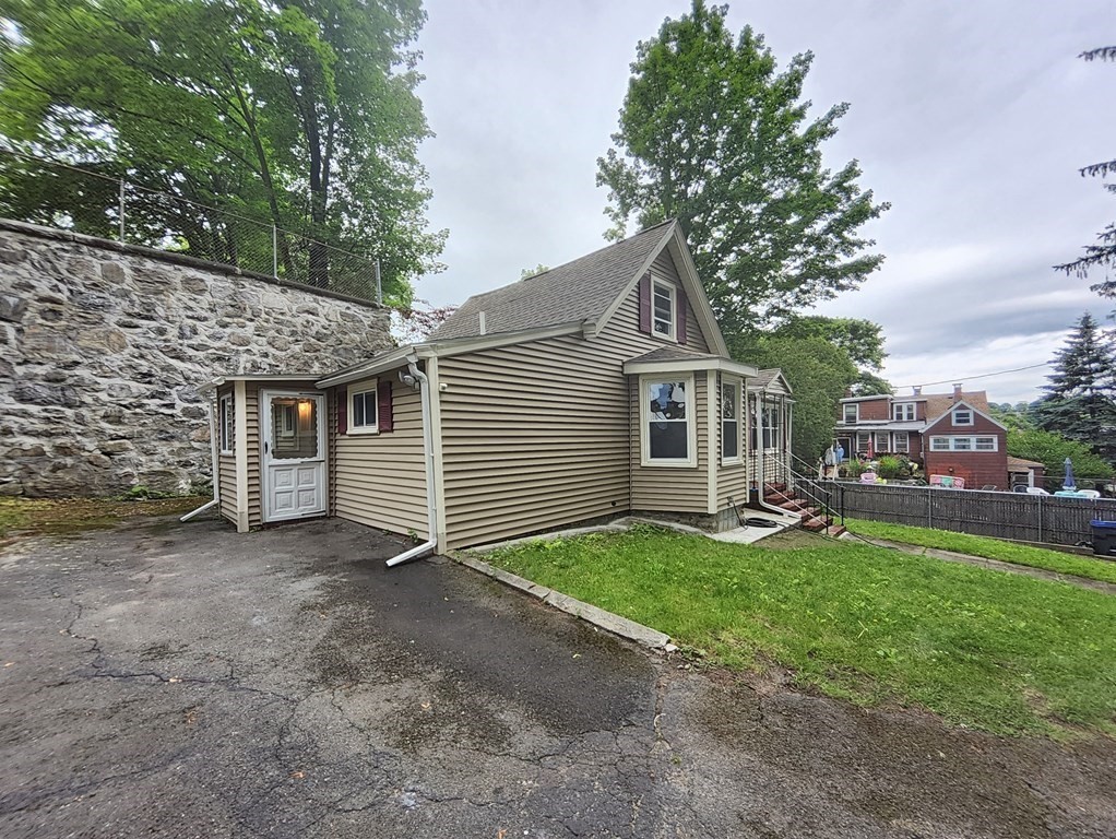 2 Grove Street Methuen, MA 01844 - Photo 2 of 15 a view of a house with a yard and sitting area