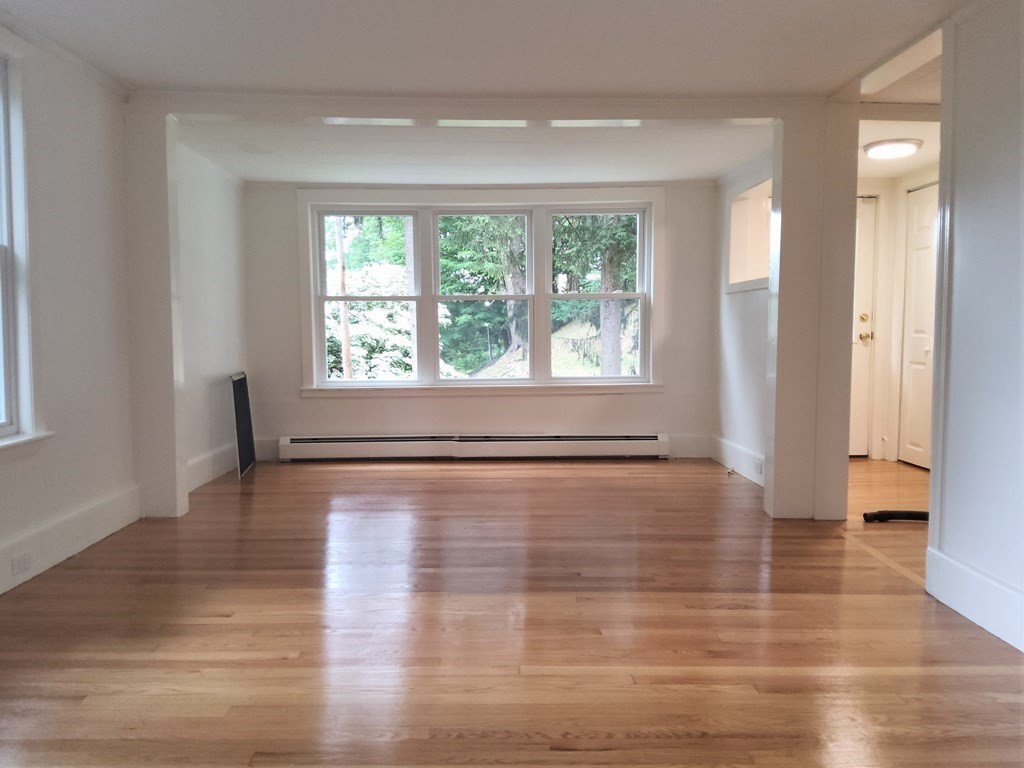 2 Grove Street Methuen, MA 01844 - Photo 4 of 15 a view of an empty room with wooden floor and a window