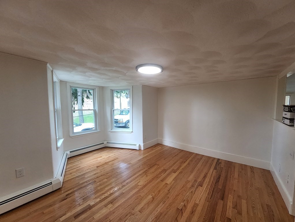 2 Grove Street Methuen, MA 01844 - Photo 7 of 15 a view of an empty room with wooden floor and a window