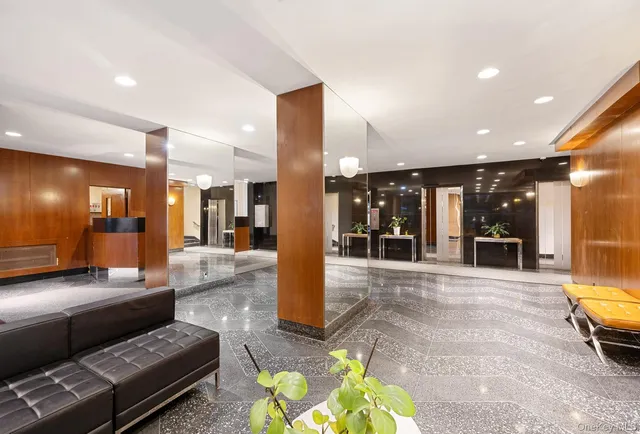 a lobby with furniture and a rug