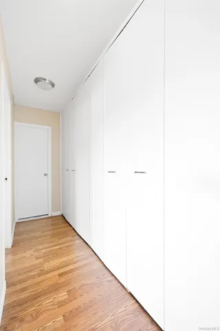 a view of a room with wooden floor