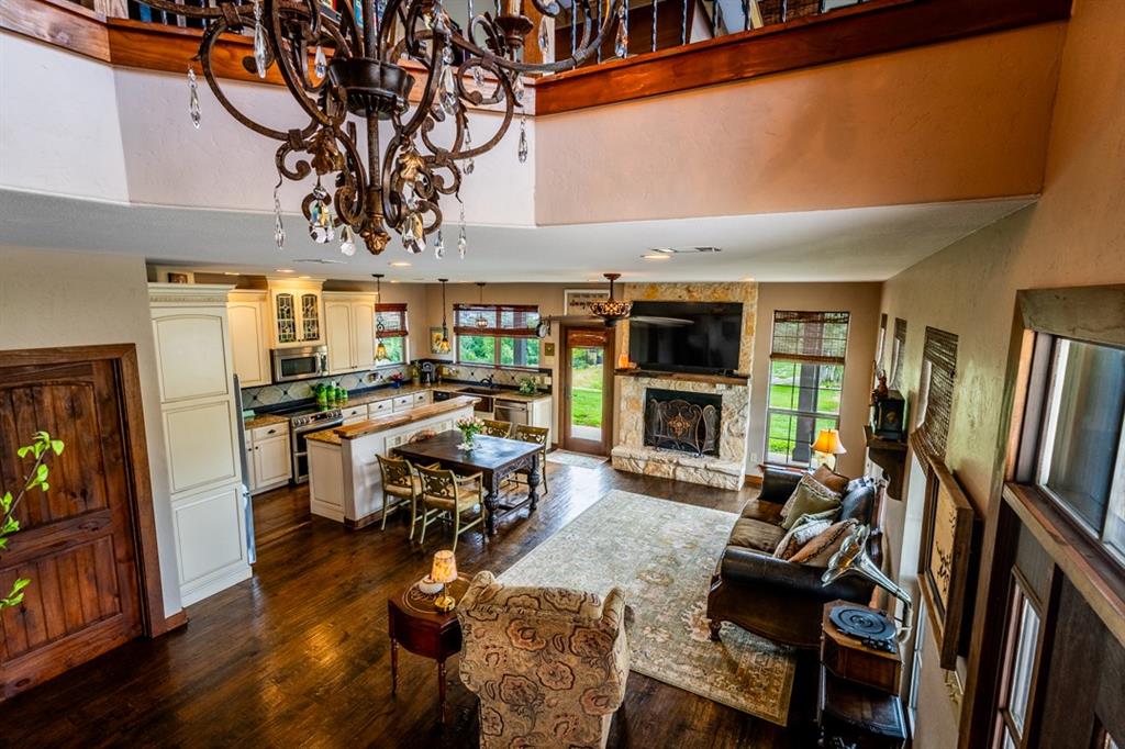 7060 Hells Gate Loop Strawn, TX 76475 - Photo 7 of 40 a living room with furniture a fireplace and a flat screen tv