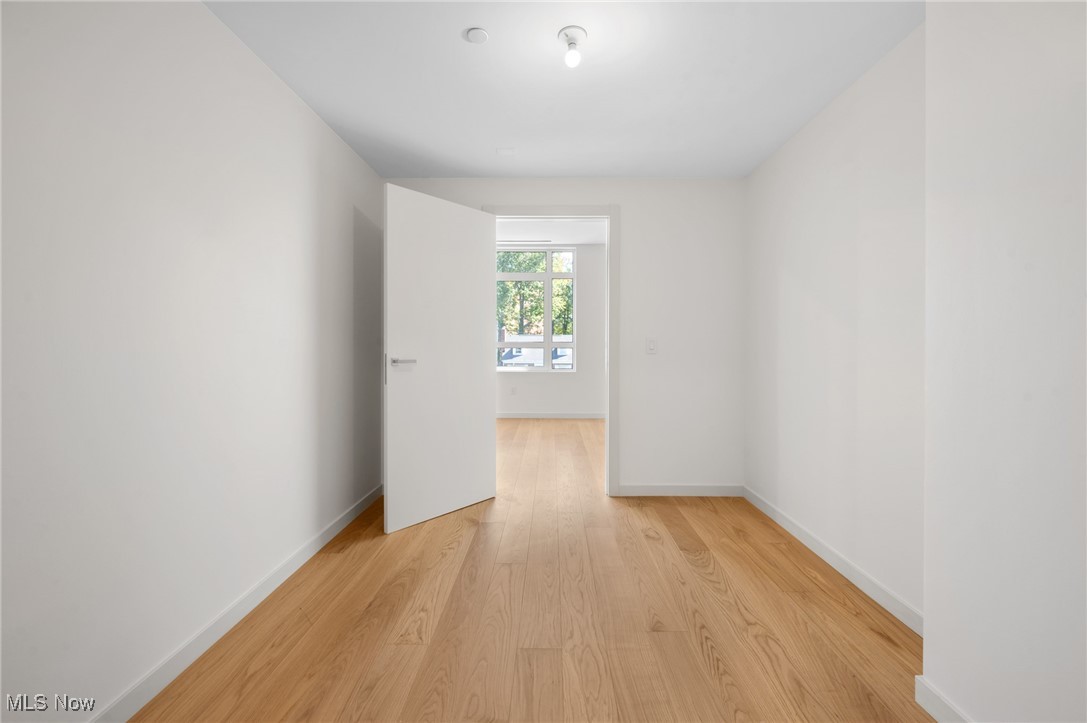 22700 Lake Road, Unit 204 Rocky River, OH 44116 - Photo 23 of 31 Empty room with light wood-style flooring and baseboards