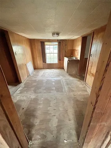 a large bedroom with a bed and wooden floor