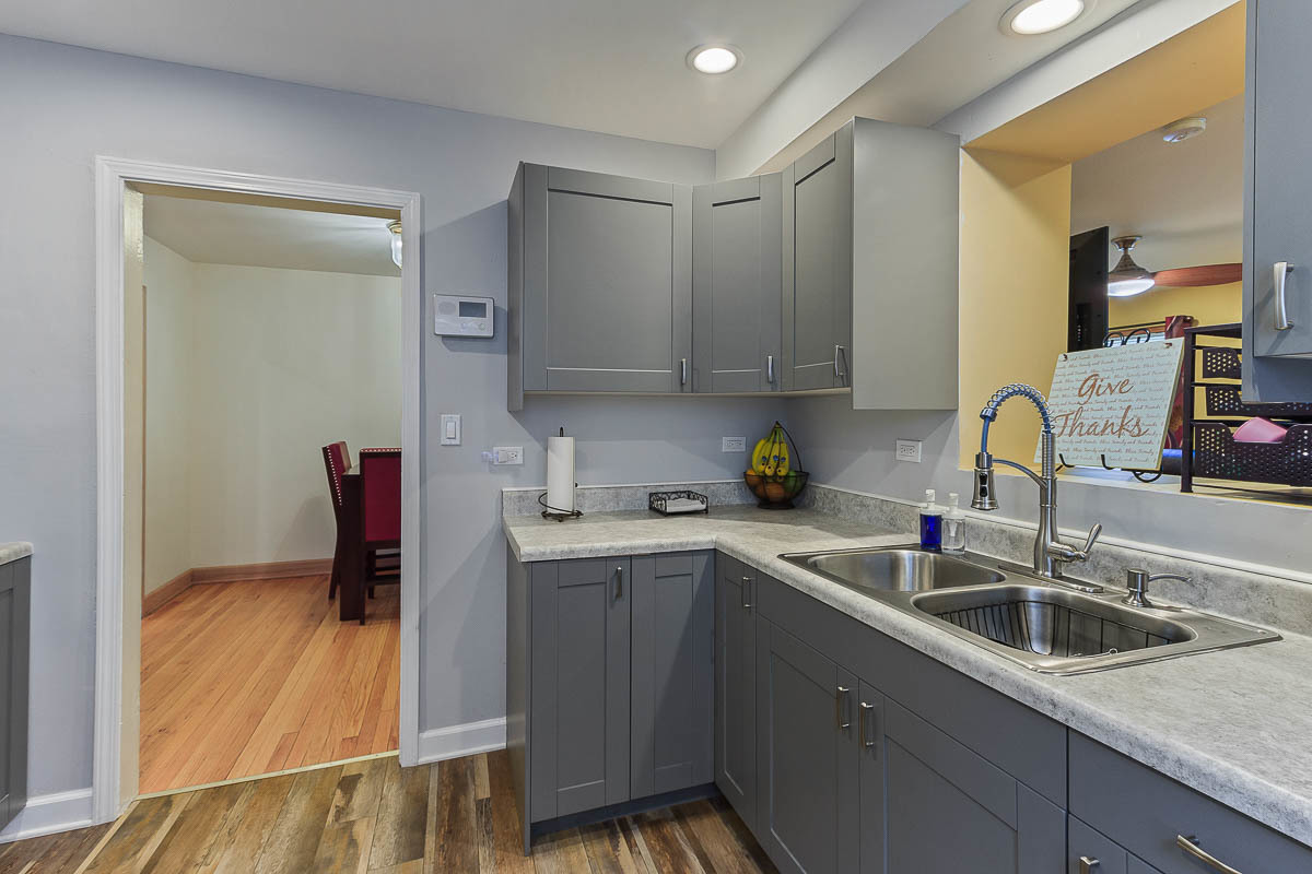 2544 East 91st Street Chicago, IL 60617 - Photo 13 of 37 a kitchen with a sink and cabinets