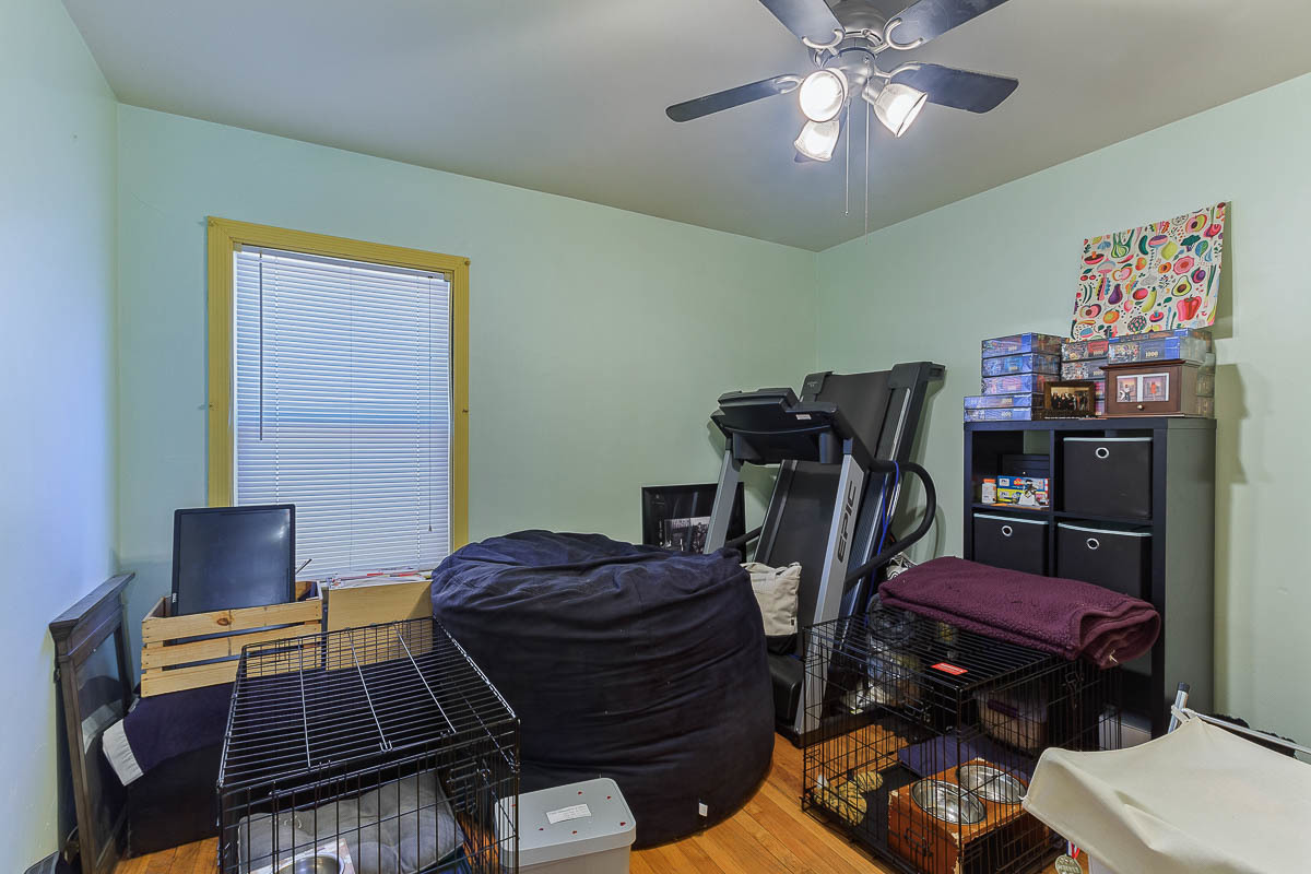 2544 East 91st Street Chicago, IL 60617 - Photo 24 of 37 a bedroom with furniture and wooden floor
