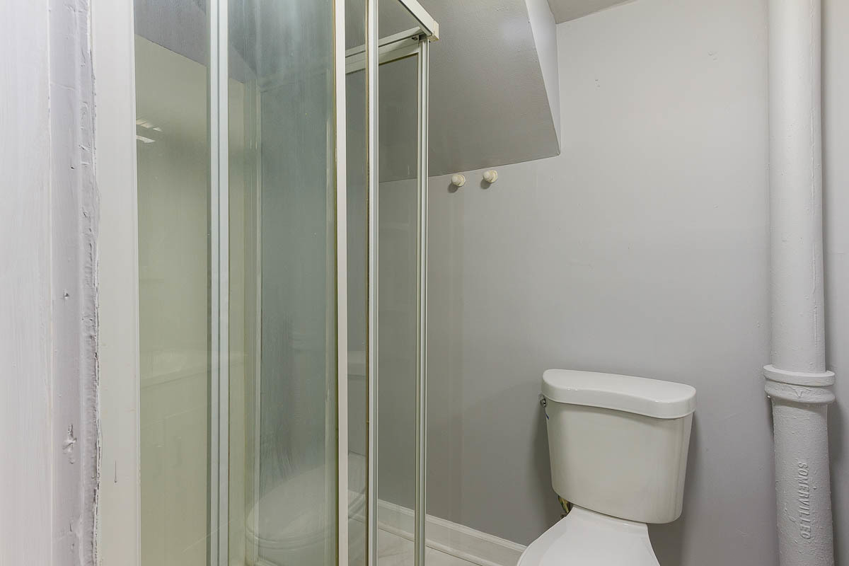 2544 East 91st Street Chicago, IL 60617 - Photo 29 of 37 a white toilet sitting next to a bathroom sink