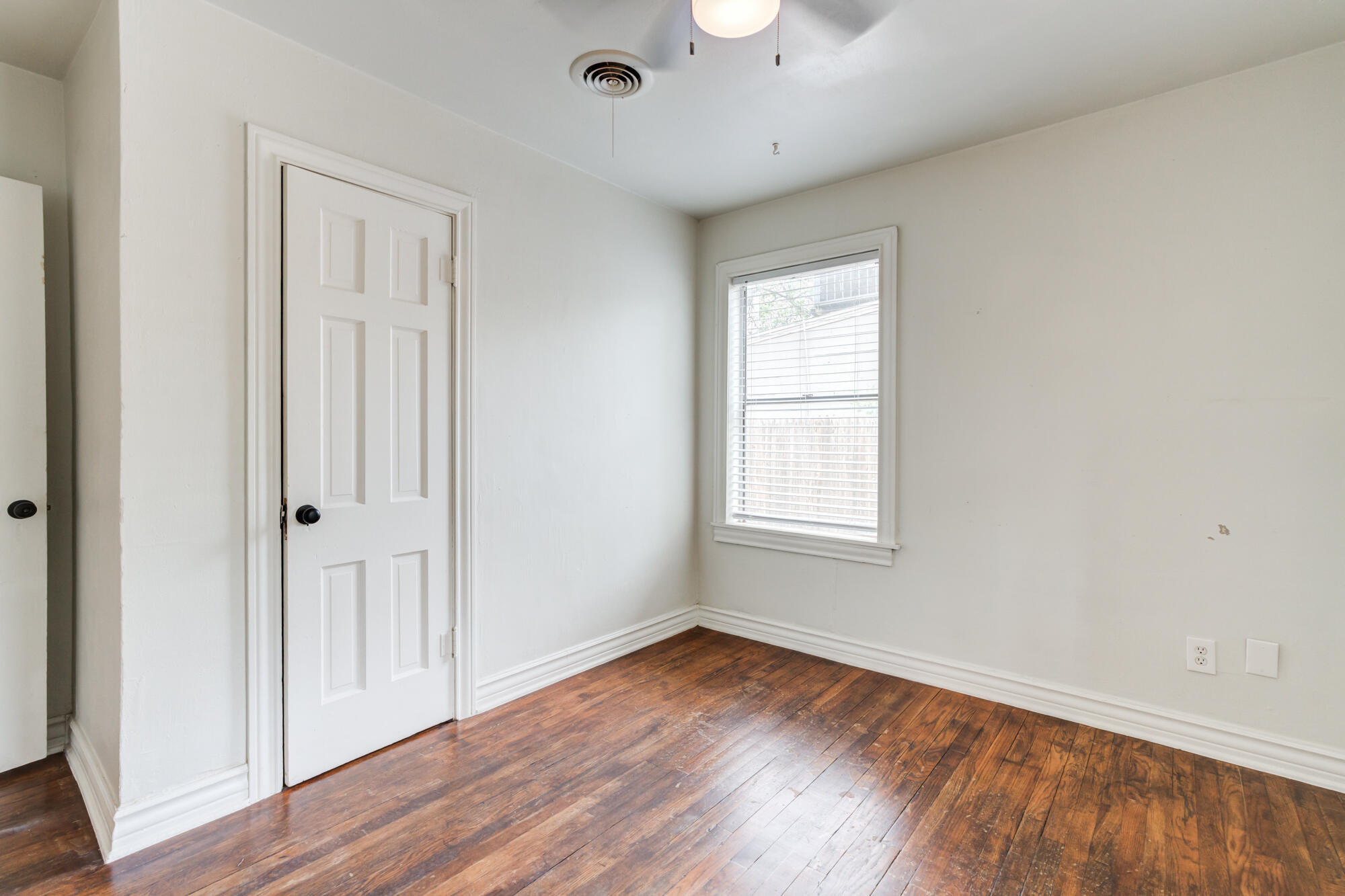 2308 30th Street Lubbock, TX 79411 - Photo 18 of 21 an empty room with wooden floor and windows