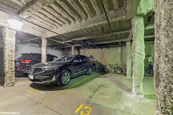 a view of parking garage with cars parked