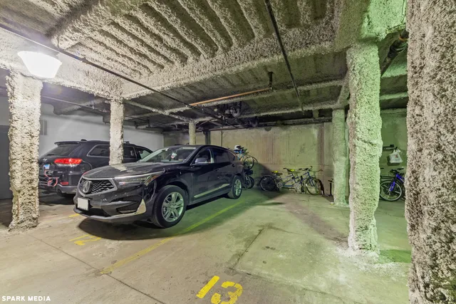 a view of parking garage with cars parked