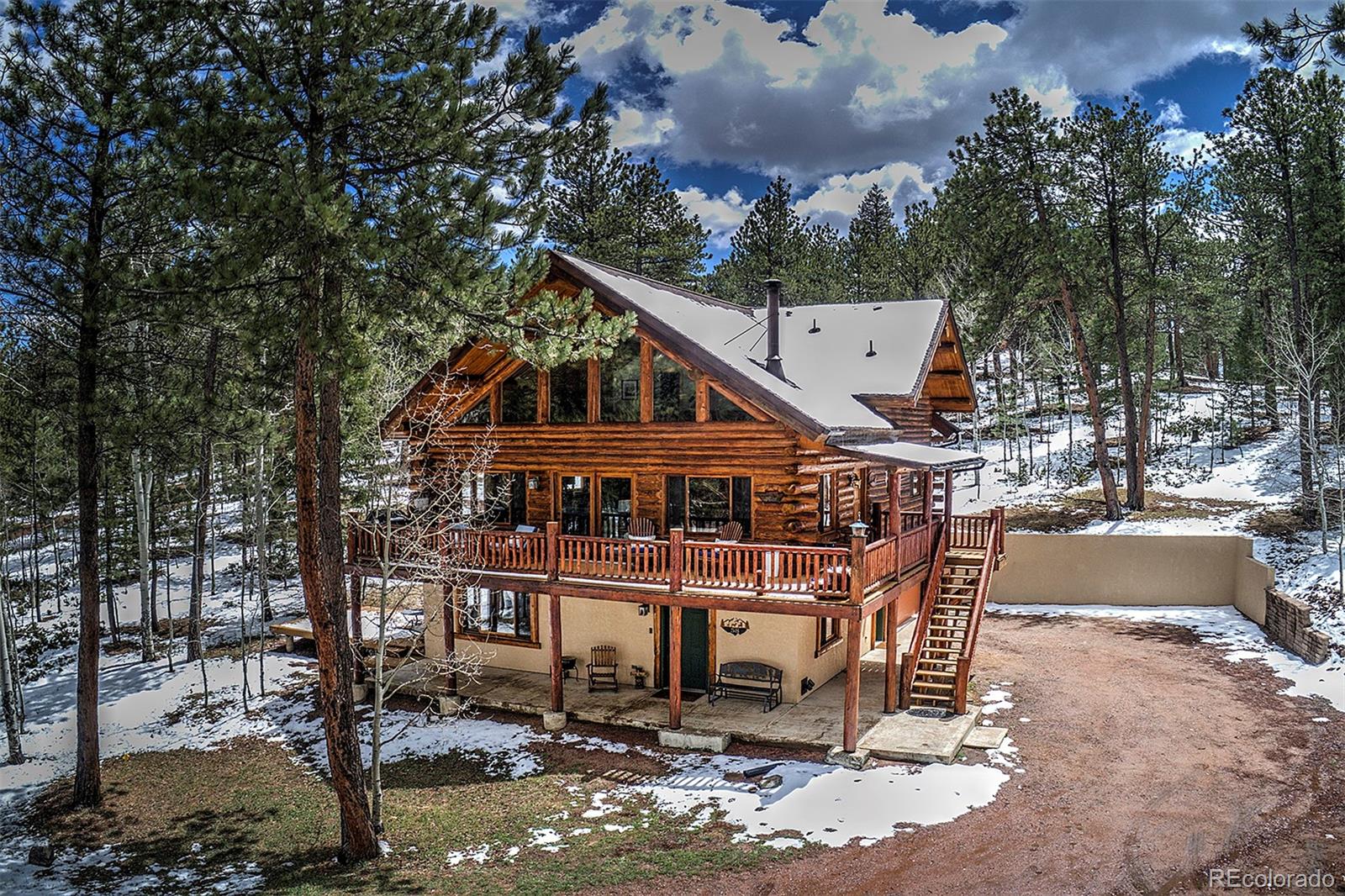 a view of a house with a wooden deck and a backyard