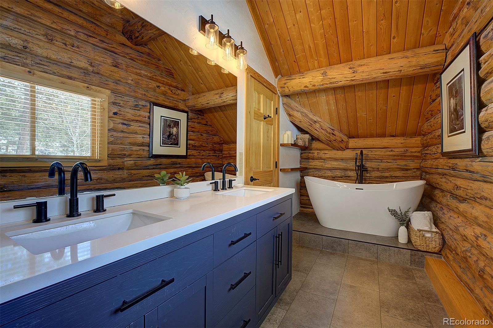 58 Conestoga Court Bailey, CO 80421 - Photo 17 of 37 a bathroom with a double vanity sink and a bathtub