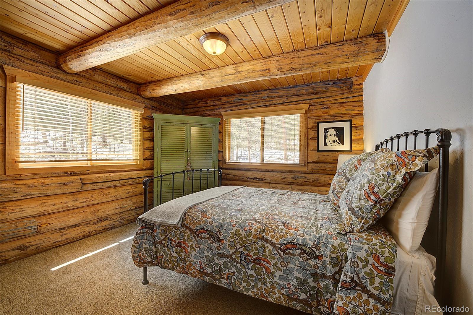 58 Conestoga Court Bailey, CO 80421 - Photo 23 of 37 a bed sitting in a bedroom next to a window