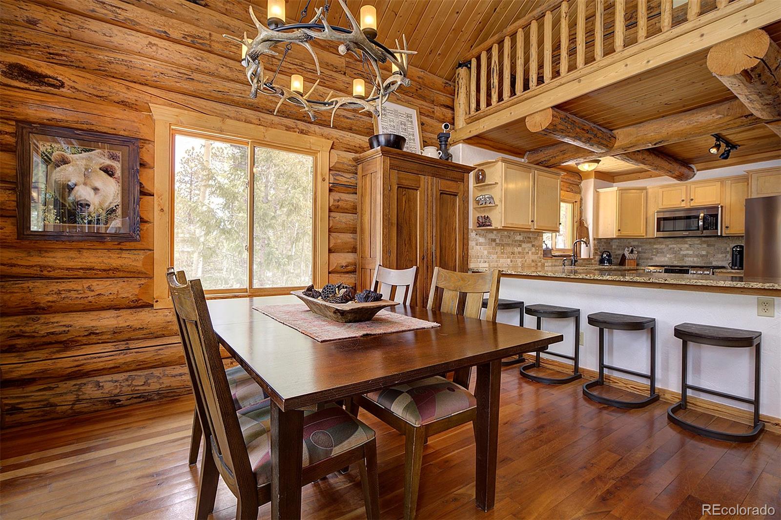 58 Conestoga Court Bailey, CO 80421 - Photo 7 of 37 a view of a dining room with furniture window and wooden floor