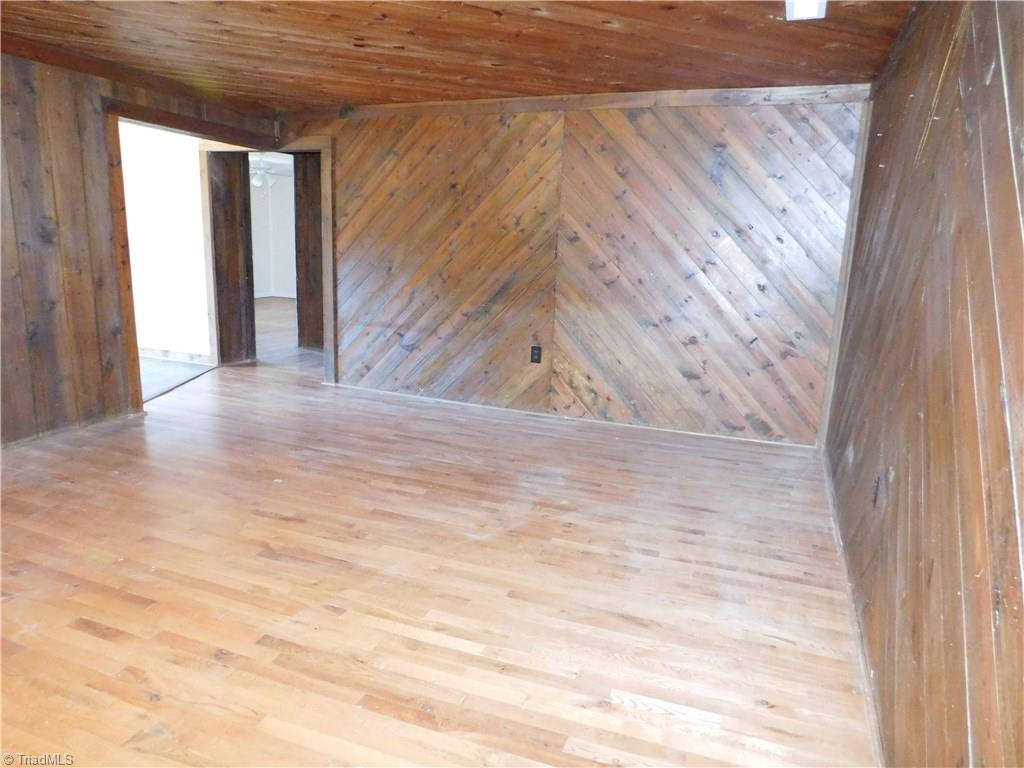 896 Bescher Chapel Road Trinity, NC 27370 - Photo 8 of 17 den with wood floors, walls 7 ceilings