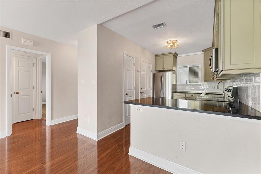 301 South Gulfstream Avenue, Unit 302 Sarasota, FL 34236 - Photo 13 of 25 a kitchen with stainless steel appliances granite countertop a refrigerator a sink and a stove