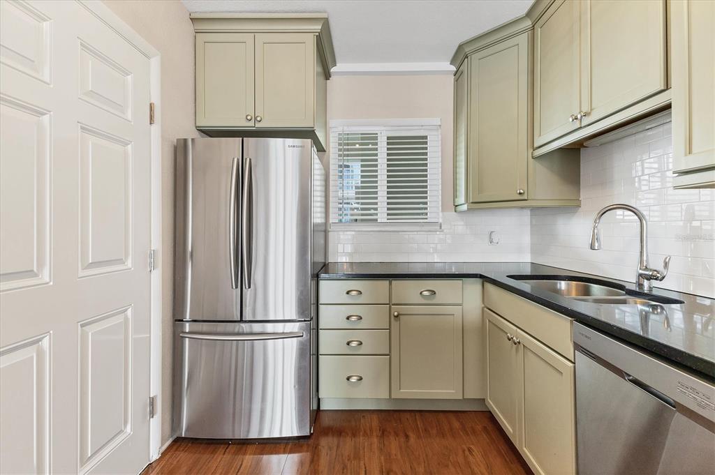 301 South Gulfstream Avenue, Unit 302 Sarasota, FL 34236 - Photo 15 of 25 a kitchen with stainless steel appliances granite countertop a refrigerator sink and cabinets