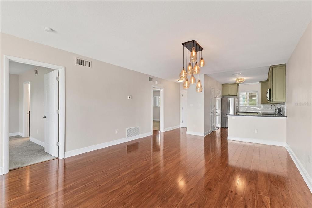 301 South Gulfstream Avenue, Unit 302 Sarasota, FL 34236 - Photo 18 of 25 a view of a big room with wooden floor and a kitchen