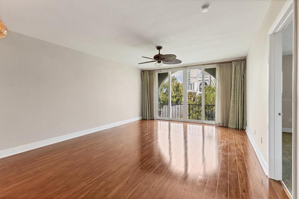 301 South Gulfstream Avenue, Unit 302 Sarasota, FL 34236 - Photo 7 of 25 a view of an empty room with wooden floor and a window
