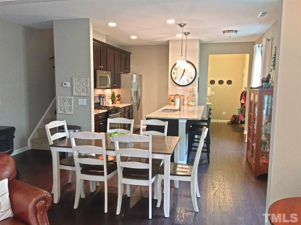 724 Wickham Ridge Road Apex, NC 27539 - Photo 3 of 22 a view of a dining room with furniture window and wooden floor