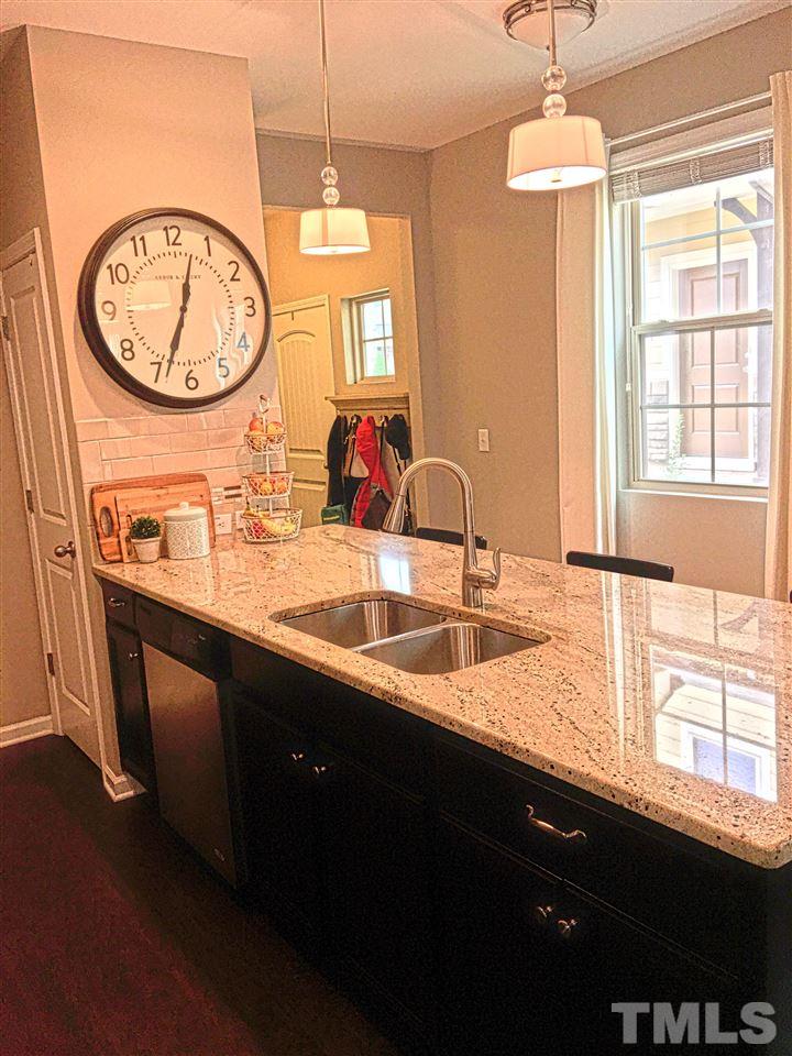 724 Wickham Ridge Road Apex, NC 27539 - Photo 8 of 22 a bathroom with a sink and a large mirror