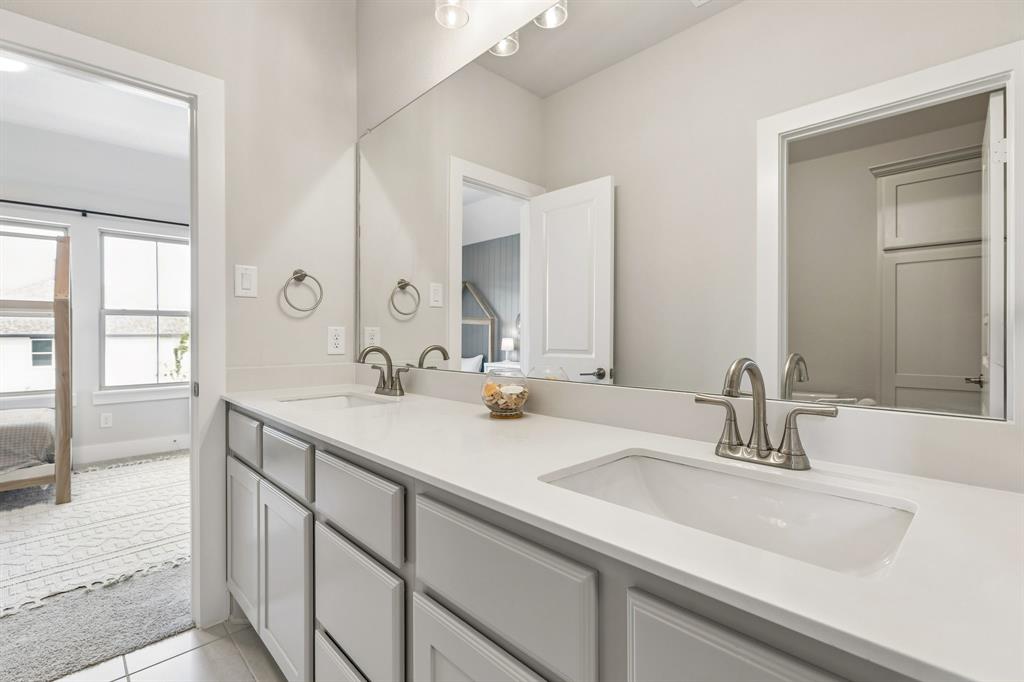 3004 Windy Rdg Road McKinney, TX 75071 - Photo 28 of 40 a bathroom with double vanity sinks and a large mirror