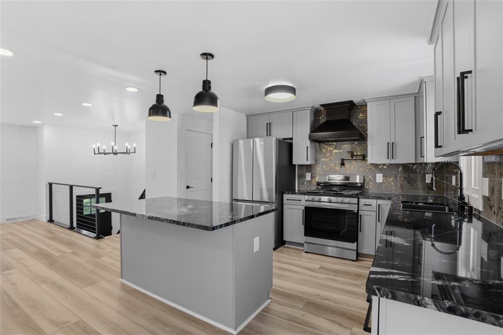 32 Green Oak Drive Coraopolis, PA 15108 - Photo 11 of 40 a kitchen with granite countertop a refrigerator stove top oven and sink