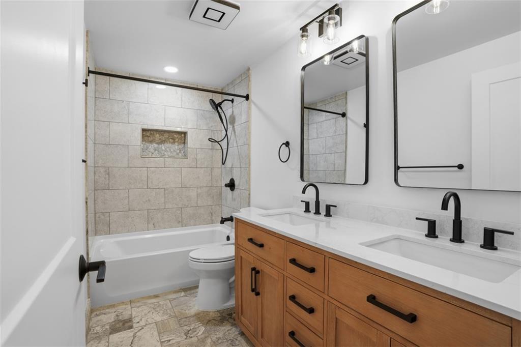 32 Green Oak Drive Coraopolis, PA 15108 - Photo 19 of 40 a bathroom with a double vanity sink toilet mirror and shower