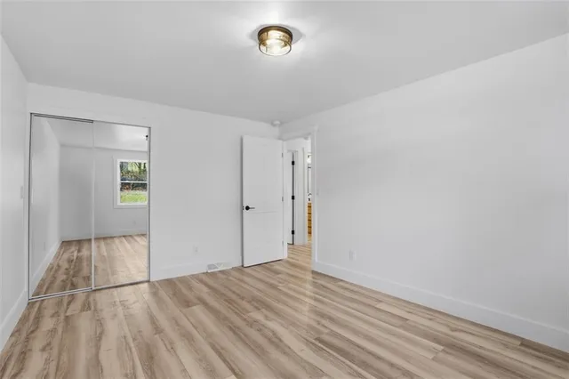 a view of an empty room and wooden floor