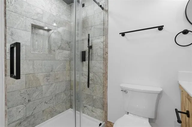 a bathroom with a shower and toilet