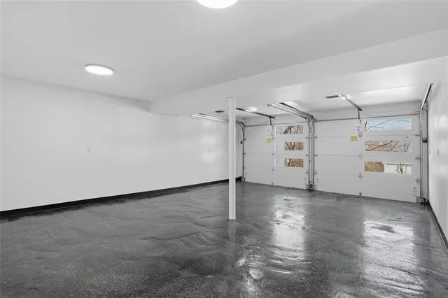 en empty room with white walls and wooden floors