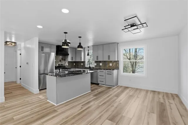 a kitchen with a refrigerator and window