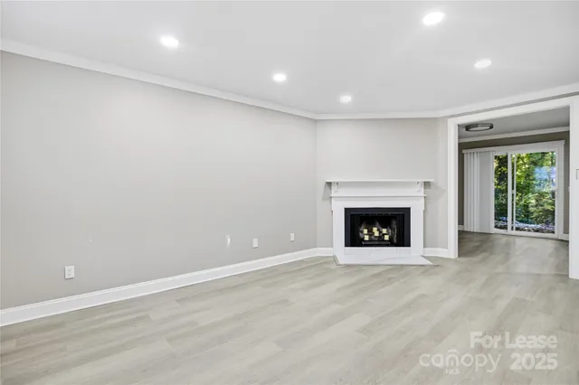 an empty room with a fireplace and window