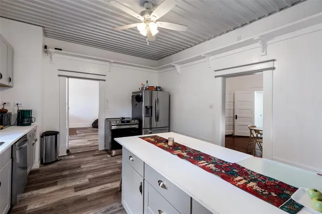 a kitchen with a stove and a refrigerator
