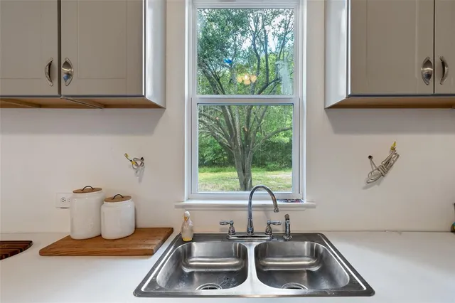 a bathroom with a sink and a window
