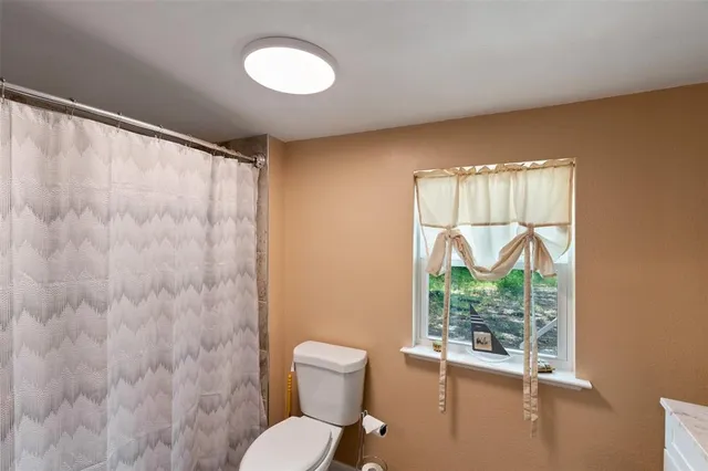 a spacious bedroom with a bed and a large window