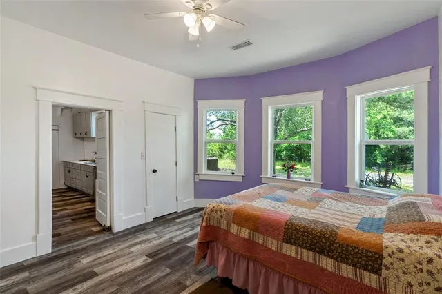 a bedroom with a bed and window