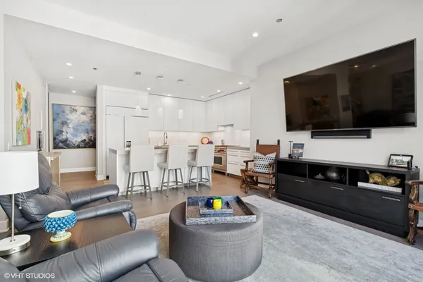 a living room with furniture and a floor to ceiling window
