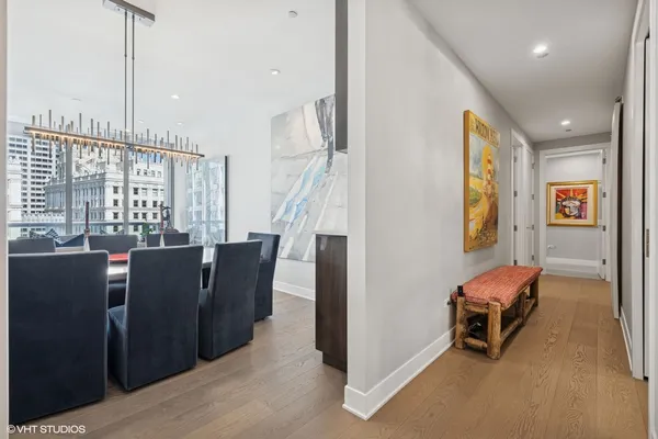 a bedroom with a bed couch and large window