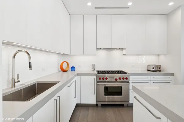 a kitchen with a stove sink and a refrigerator