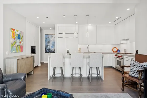 a living room with furniture and kitchen view