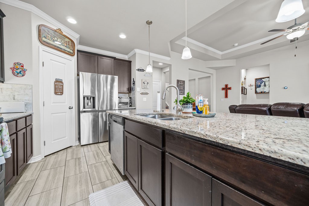 1021 Pasadena Street Portland, TX 78374 - Photo 11 of 37 a kitchen with granite countertop a refrigerator a sink and wooden floor