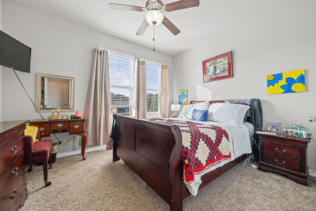 1021 Pasadena Street Portland, TX 78374 - Photo 16 of 37 a bedroom with a bed and a chandelier