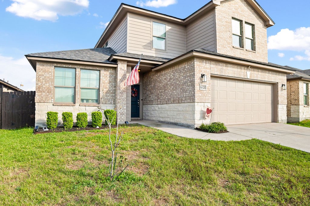 1021 Pasadena Street Portland, TX 78374 - Photo 2 of 37 a front view of a house with a yard and garage