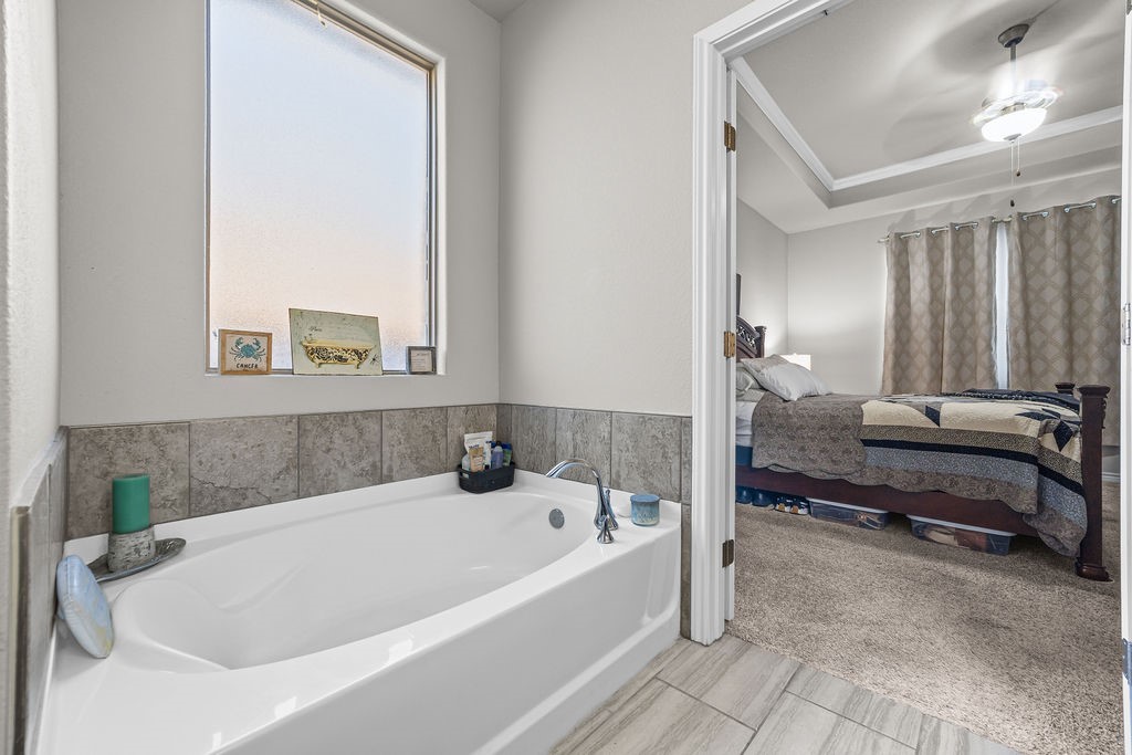 1021 Pasadena Street Portland, TX 78374 - Photo 25 of 37 a bathroom with a tub and a view of living room