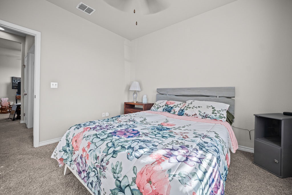 1021 Pasadena Street Portland, TX 78374 - Photo 33 of 37 a bedroom with a bed and a fireplace