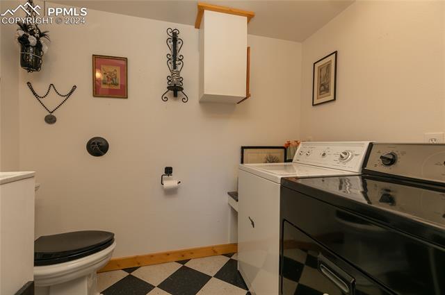 622 Sioux Road Florissant, CO 80816 - Photo 27 of 43 Laundry room featuring tile floors and washing machine and clothes dryer