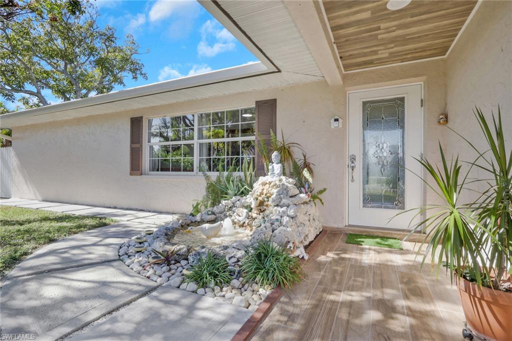 4983 18th Court Southwest Naples, FL 34116 - Photo 1 of 37 a front view of a house with garden