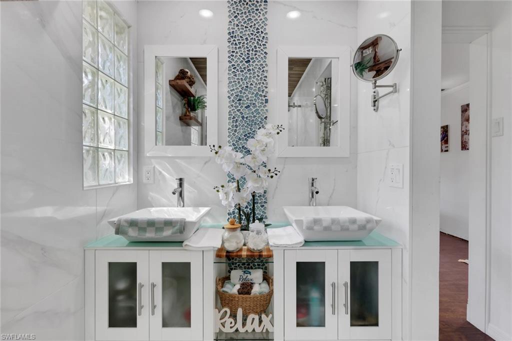 4983 18th Court Southwest Naples, FL 34116 - Photo 16 of 37 a kitchen with a refrigerator and a chandelier